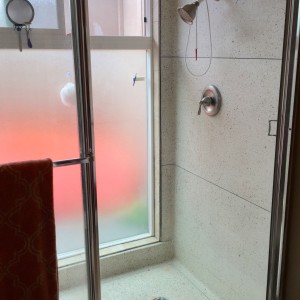 super original and mostly cool master shower. love the terrazzo, wouldn't mind replacing the glass and the shower head.