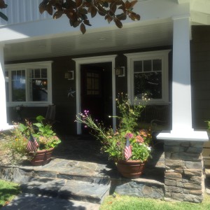welcoming front porch - i love square columns and quality stonework!