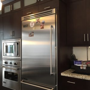 rich espresso cabinets pair nicely with the stainless steel appliances