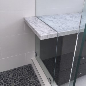 master bath details. carrera marble extends from the counter top into the shower stall.