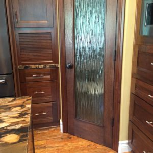 appliance garage in the cabinetry. pantry with custom glass door